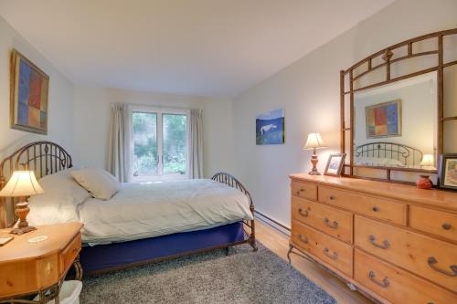 a bedroom with a bed and a dresser and a window at Waitsfield Condo with Pool and On-Site Trail Access! in Waitsfield