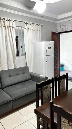 a living room with a couch and a refrigerator at 10 MIN AEROPORTO GUARULHOS in Guarulhos