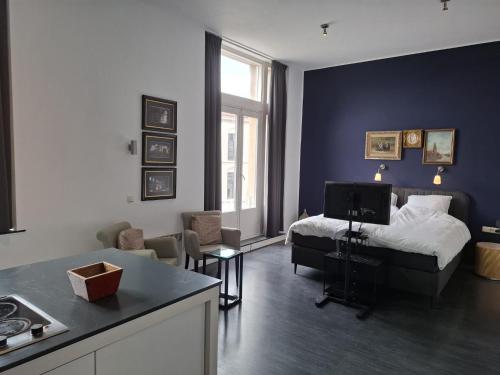 a bedroom with a bed and a living room at 't Venlogement in Venlo