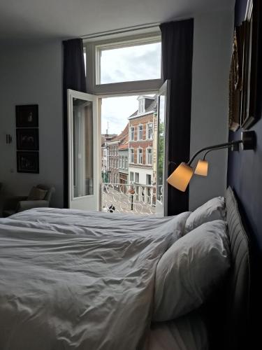 a bedroom with a large bed and a window at 't Venlogement in Venlo