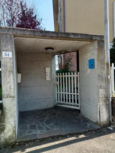 an entrance to a garage with a white gate at B&B vittoria in Bazzano