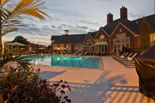 a large swimming pool in front of a house at Walkable Pet-friendly 2br2ba On 1st Floor! in Westerville