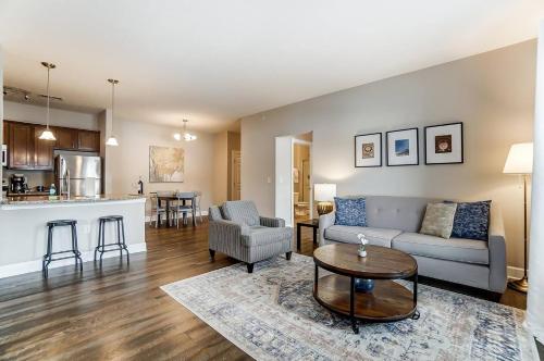 a living room with a couch and a table at Walkable Pet-friendly 2br2ba On 1st Floor! in Westerville