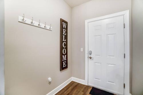 a room with a white door and a sign on the wall at Walkable Pet-friendly 2br2ba On 1st Floor! in Westerville