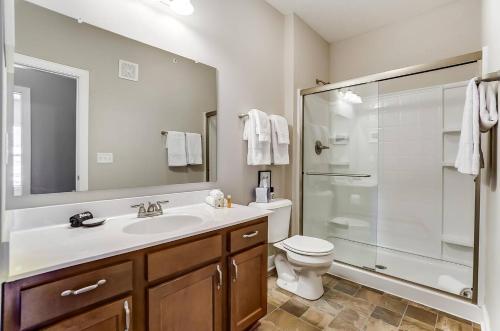 a bathroom with a toilet and a sink and a shower at Walkable Pet-friendly 2br2ba On 1st Floor! in Westerville