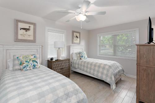 a bedroom with two beds and a ceiling fan at 1700 Bruce Drive in Saint Simons Island