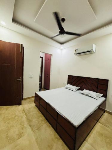 a bedroom with a bed with a ceiling fan at Stay Royal BNB - Luxury Villa in Kharar