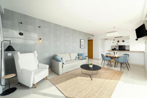 a living room with a couch and a table at Agua Hotels Riverside in Ferragudo