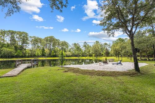 a park with a picnic table and a lake at Private Farm with Beach Near St Johns River 