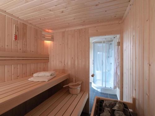 a wooden sauna with a bench and a window at Coast Calm 71 in Colijnsplaat