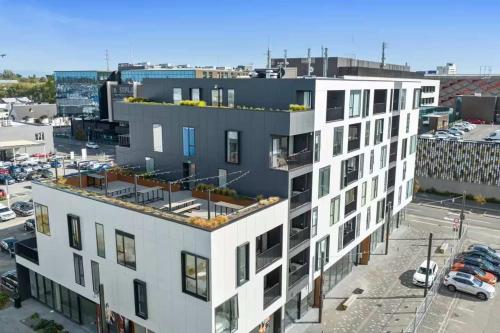 an aerial view of a white building with a parking lot at Serene Spaces on Tuam - 2 Bedroom Apartment in Christchurch