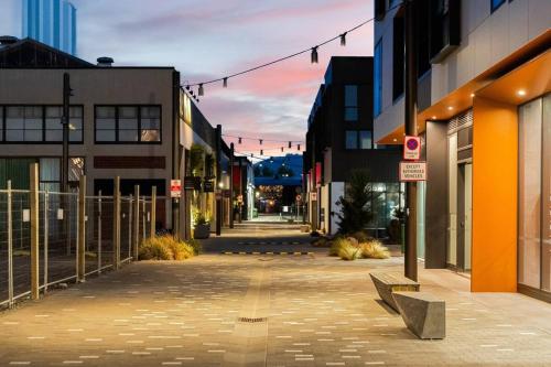 an empty street in a city with buildings at Serene Spaces on Tuam - 2 Bedroom Apartment in Christchurch