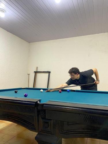 a man standing next to a pool table at 03- Cachoeiras do Pinga, Tianguá in Tianguá