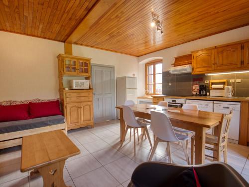 une cuisine avec une table et des chaises dans une pièce dans l'établissement Maison de village avec jardin clos, sauna et télécabine à 500m - idéal pour famille! - FR-1-642-16, à Morillon