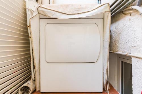 a washing machine sitting next to a wall at Fridays Flats Dreamy Duplex - Stylish Beach Loft in Barcelona