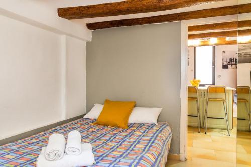 a bedroom with a bed with a yellow pillow and chairs at Fridays Flats Dreamy Duplex - Stylish Beach Loft in Barcelona