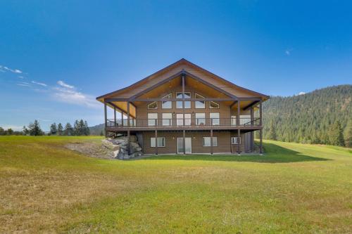 a large house in the middle of a field at Mountain and Lake View Rexford Estate on 28 Acres! in Rexford