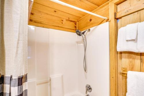 a bathroom with a shower and a toilet at Bear In Flannel Cabin Hot Tub in Townsend