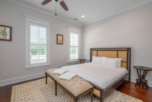 a bedroom with a large bed and two windows at Rose House - 2 Primary Suites, Easy Parking in Savannah
