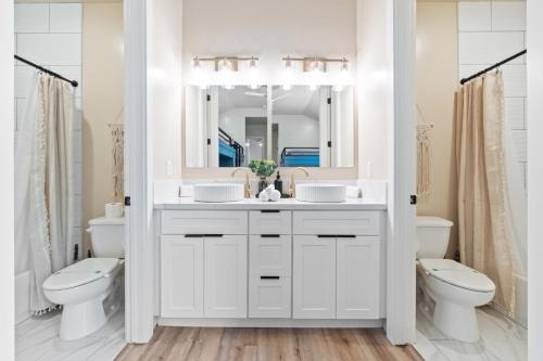 a bathroom with a sink and a toilet and a mirror at Its about time, for adventure in Hurricane