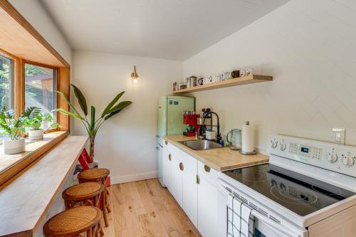 a kitchen with a sink and a counter with stools at Private Hilltop Retreat Near Windham Mountain in Windham