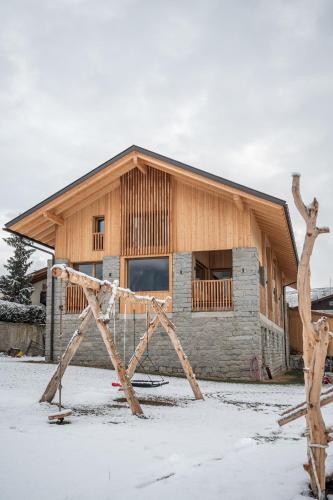 a house in the snow in front of a building at Stadl Chalet oberhalb Brixen in Rosa