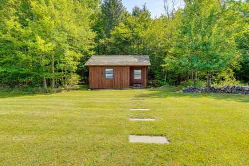 a small cabin in the middle of a grass field at Private Hilltop Retreat Near Windham Mountain in Windham
