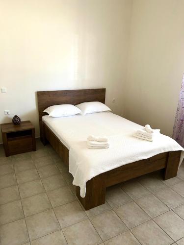 a bedroom with a bed with two towels on it at Vira Apartment in Pherrai