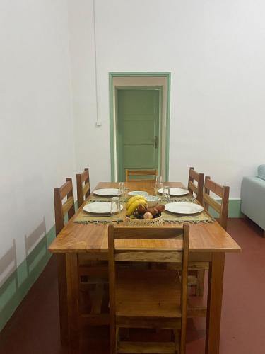 a wooden table with a bunch of fruit on it at CASA da Baía by NaturAlegre in São Tomé