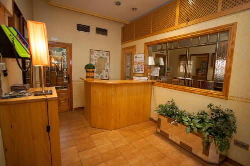 a restaurant with a cashier and a counter in a room at Hostal Aragon in Ejea de los Caballeros