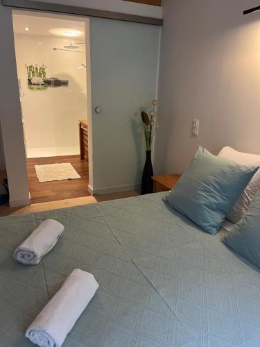 a bedroom with a bed with two towels on it at l'abri du bonheur in Lampertheim