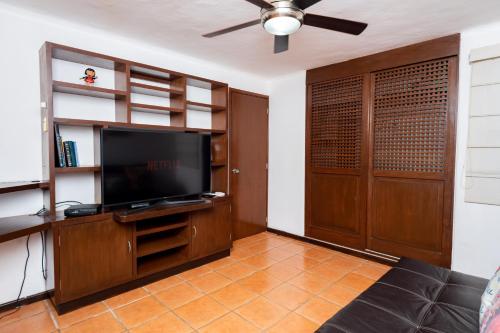 a living room with a flat screen tv and a couch at Apartamento amplio en zona ideal a 5min de WALLMART in Cancún