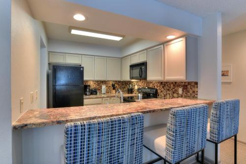 a kitchen with white cabinets and a counter top at Wedgewood Lodge in Breckenridge