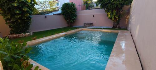 a swimming pool in the backyard of a house at Casa Eclipse in Cancún