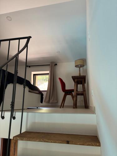 a room with a bunk bed and a chair at Mas des quatre cyprès in Spéracèdes