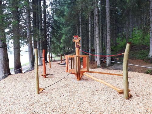 a park with a swing set in the woods at Die Filzmooserin - Apartments in Filzmoos, Filzmoos Card inklusive in Filzmoos