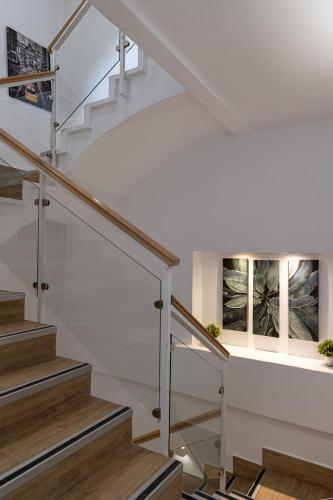a staircase in a house with white walls and wooden floors at Hotel Marina Benalmádena in Benalmádena