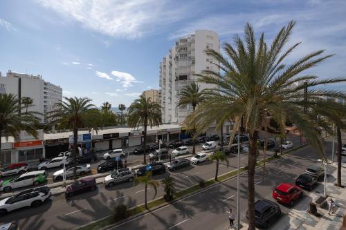a city with cars parked in a parking lot at Hotel Marina Benalmádena in Benalmádena
