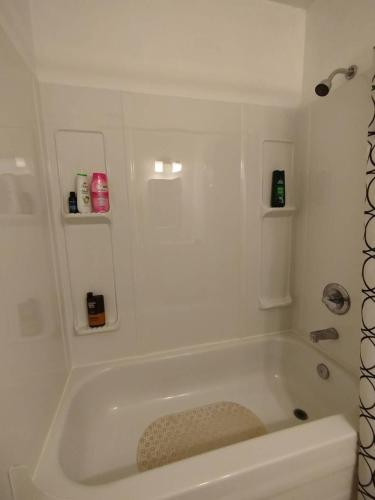 a white bath tub in a bathroom at Jenny Guest House in Yellowknife