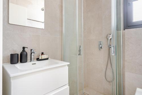 a bathroom with a sink and a shower at YAMAS Urban Living SEQUOIA Residence in Limassol