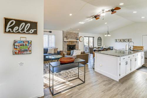 a living room with a kitchen and a living room with a table at Lake View and Deck Group Getaway in Whitehall! in Whitehall
