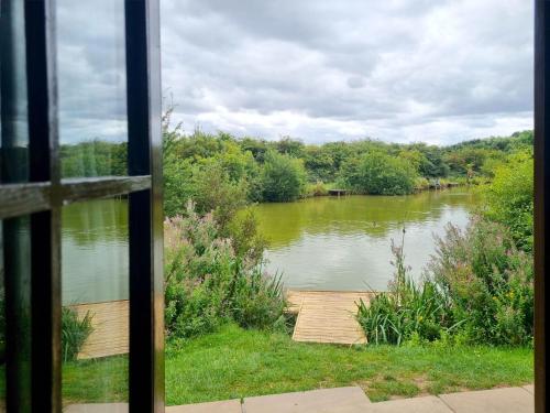 a view of a river from a window at Oak 9 Hot Tub in Garton