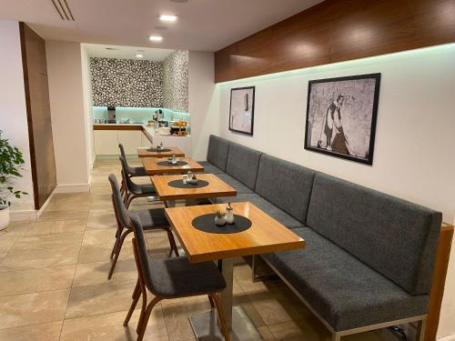 a row of tables and chairs in a restaurant at B&B Villa Hotel in Mariánské Lázně
