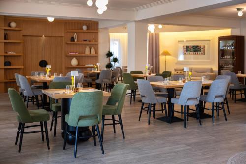 a dining room with tables and chairs in a restaurant at Armonia by Aristocratis in Tîrgu Neamţ