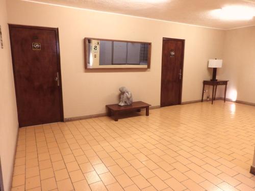 an empty room with a tv on the wall at Oriente Express Lodging in Chincha Alta