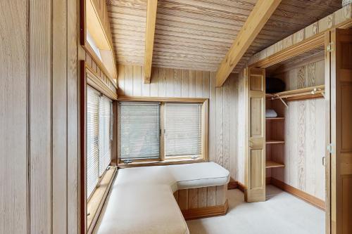 a room with a bench in front of a window at Cypress Cove in Sea Ranch