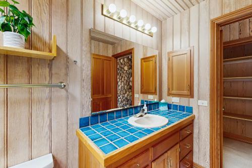 a bathroom with a sink and a mirror at Cypress Cove in Sea Ranch