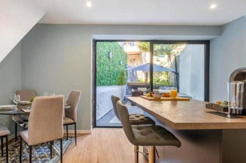 a kitchen and dining room with a table and chairs at Madeira House by Mathias in Funchal