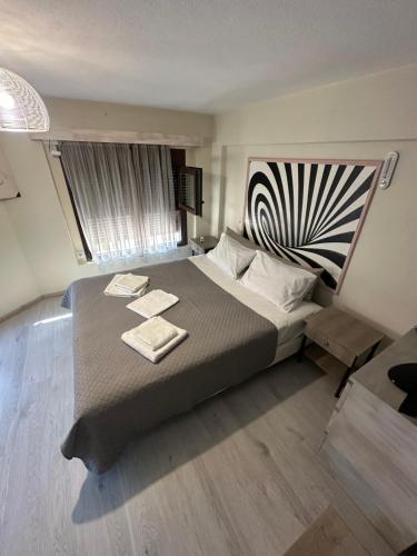 a bedroom with a large bed with two towels on it at Lajes Apartment in Skala Potamias