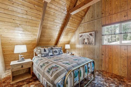 a bedroom with a bed in a wooden cabin at The Kachina Cabin in Mountainaire